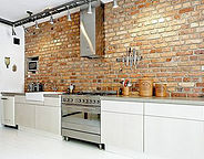 White Kitchen cabinets with brick backsplash